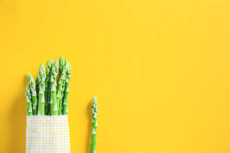 Asparagus. Fresh Asparagus. Pickled Green Asparagus. Bunches of green asparagus on yellow.の写真素材