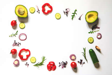 Creative layout of tomatoes, cucumbers, bell peppers, avocados and salads. flat lay. Food concept. place for your text.の写真素材