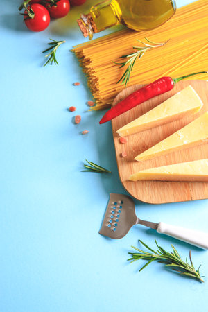 Uncooked pasta on blue background. Top view. Raw pasta with ingredients for cooking. Food concept. Italian food.の写真素材