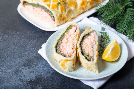 Homemade Salmon Wellington. It is made from Salmon Fish, spinach, mushrooms, spices, herbs and puff pastry. Copy spaceの写真素材
