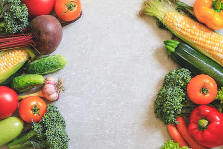 Healthy food background. Healthy vegan vegetarian food. Fresh raw salad ingredients, vegetables tomatoes cucumbers lettuce pepper. copy space, selective focusの写真素材