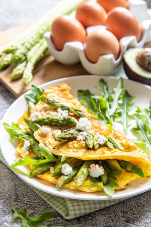 Gourmet Tasty Egg Omelette with Asparagus and soft Cheese. Asparagus. Fresh Asparagus with eggs.の写真素材