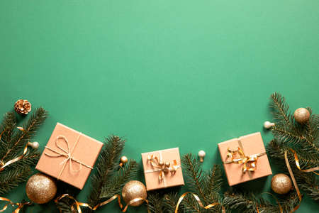 christmas gift boxes with christmas accessories on green background. Preparing for the holidays. Top view with copy space.の写真素材
