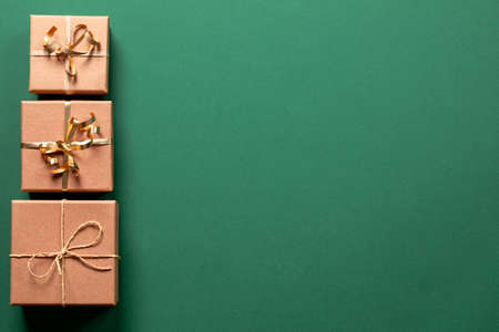 christmas gift boxes with christmas accessories on green background. Preparing for the holidays. Top view with copy space.の写真素材