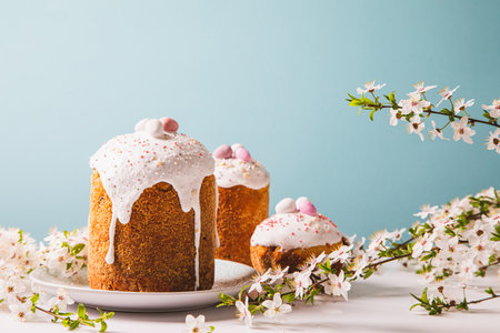 Easter cake with glace icing and decoration. Postcard with Easter bread. Christian tradition. copyspace. white backgroundの写真素材