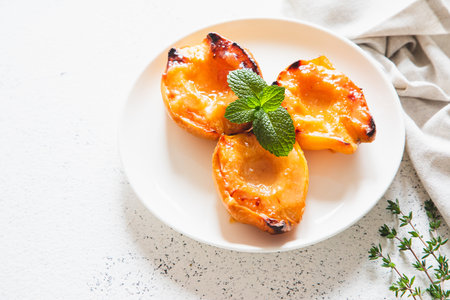 Apple quince baked with honey on a white plate with ice cream. Healthy vegetarian dessert.の写真素材