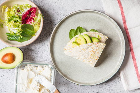 Cooking process for sandwich and ingredients. Process of prepare quesadilla with avocado, salmon, curd cheese and spinach. Trendy wrap hack. step by step. Step 4の写真素材