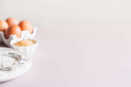 Baking or cooking background frame. Ingredients, kitchen items for baking cakes. Kitchen utensils, flour, eggs, brown sugar, butter. Text space, top view. Cookies Pie Or Cake Recipe Mockupの写真素材