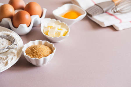 Baking or cooking background frame. Ingredients, kitchen items for baking cakes. Kitchen utensils, flour, eggs, brown sugar, butter. Text space, top view. Cookies Pie Or Cake Recipe Mockupの写真素材