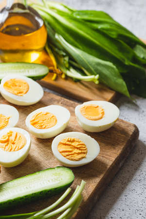 Ingredients for a healthy salad - leeks, boiled eggs, cucumber. concept of healthy eating and keto diet.の写真素材