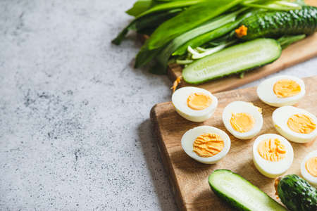 Ingredients for a healthy salad - leeks, boiled eggs, cucumber. concept of healthy eating and keto diet.の写真素材