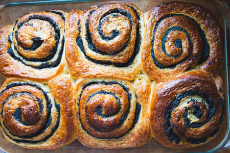 sweet twisted buns with poppy seeds. Swirl brioche with poppy seeds.の写真素材