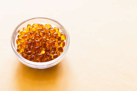 Vitamin D3 capsules. Medicine vitamins and dietary supplements. selective focus. Close up of oil filled capsules suitable for: fish oil, omega 3, omega 6, omega 9, vitamin A, vitamin D, vitamin D3, vitamin Eの写真素材