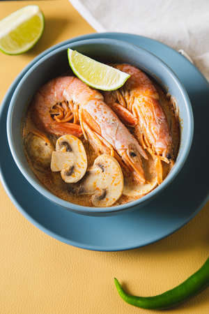 Tom Yum Goong Spicy Sour Soup on trendy table top view, Thai local foodの写真素材