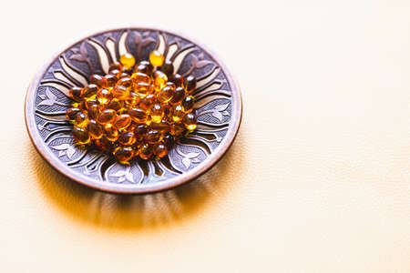 Vitamin D3 capsules. Medicine vitamins and dietary supplements. selective focus. Close up of oil filled capsules suitable for: fish oil, omega 3, omega 6, omega 9, vitamin A, vitamin D, vitamin D3, vitamin Eの写真素材