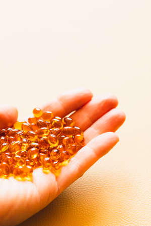 Vitamin D3 capsules. Medicine vitamins and dietary supplements. selective focus. Close up of oil filled capsules suitable for: fish oil, omega 3, omega 6, omega 9, vitamin A, vitamin D, vitamin D3, vitamin Eの写真素材