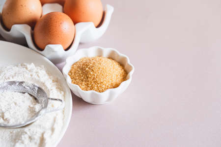 Baking or cooking background frame. Ingredients, kitchen items for baking cakes. Kitchen utensils, flour, eggs, brown sugar, butter. Text space, top view. Cookies Pie Or Cake Recipe Mockupの写真素材
