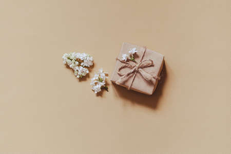 lilac flowers with eco gift box from kraft paper. Creative congratulations layout. spring flower conceptの写真素材