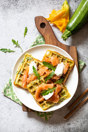 Belgian waffles with zucchini and greens with cottage cheese and salted salmon.の写真素材