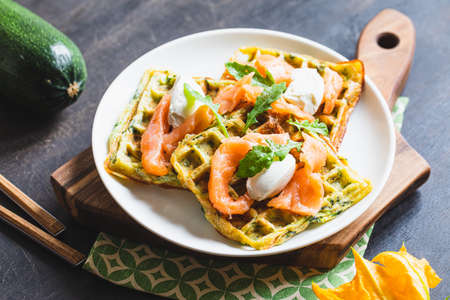 Belgian waffles with zucchini and greens with cottage cheese and salted salmon.の写真素材