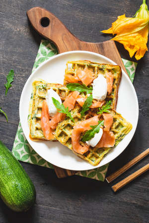 Belgian waffles with zucchini and greens with cottage cheese and salted salmon.の写真素材