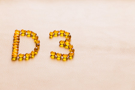 Bright oil yellow pills forming shape D3. Vitamin D3 capsules. Medicine vitamins and dietary supplements. selective focus.の写真素材