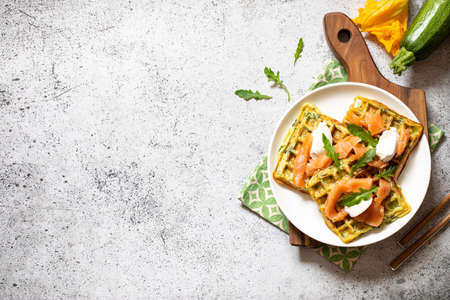 Belgian waffles with zucchini and greens with cottage cheese and salted salmon.の写真素材