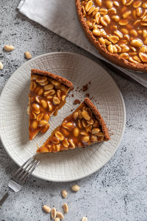 Homemade caramel-peanut cheesecake on a light background. Morning delicious bakery cake.の写真素材