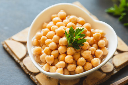 Cooked chickpeas in a white bowl. Ingredient for Tasty vegetarian food. Boiled chickpeas, selective focusの写真素材