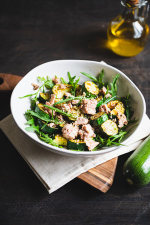 fresh salad with arugula, baked zucchini and tuna. the concept of healthy and nutritious food.の写真素材