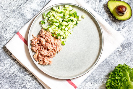 Step 3. Step-by-step preparation of a sandwich with tuna, avocado, cucumber and onionの写真素材