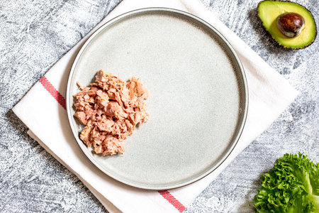 Step 2. Step-by-step preparation of a sandwich with tuna, avocado, cucumber and onionの写真素材
