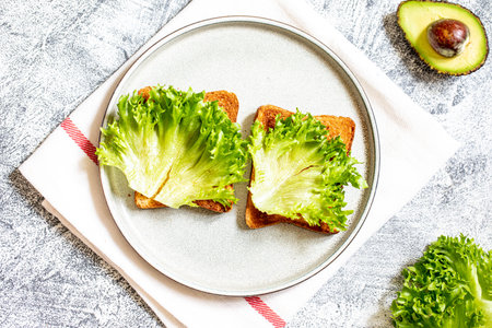 Step 10. Step-by-step preparation of a sandwich with tuna, avocado, cucumber and onionの写真素材