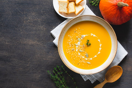 Roasted pumpkin and carrot soup with pumpkin and hemp seeds. Pumpkin traditional soup with creamy silky textureの写真素材