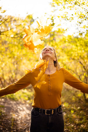 Beautiful woman in autumn park. happiness, harmony, self-care, relaxation and mindfullness.の写真素材