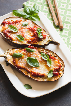baked eggplant with tomatoes and mozzarella and basil.の写真素材