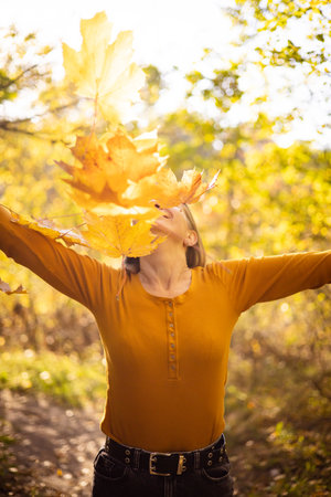 Beautiful woman in autumn park. happiness, harmony, self-care, relaxation and mindfullness.の写真素材