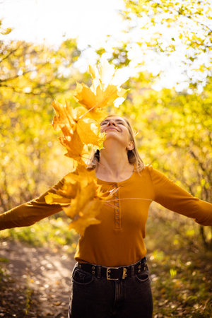 Beautiful woman in autumn park. happiness, harmony, self-care, relaxation and mindfullness.の写真素材