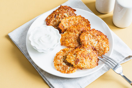 Potato pancakes or latkes or draniki with sour cream. Ukrainian food. A grated potato dish of Deruny or Dranikiの写真素材