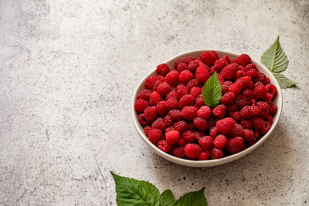 Fresh raspberries in bowl. Ripe juicy fresh raspberries. Organic raspberries, healthy food, vitamins, summer berry fruit.の写真素材