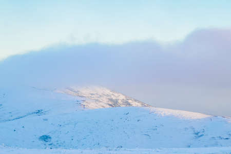 Snowy mountains in the fogの写真素材