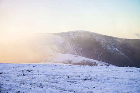 Landscape with high snow covered mountains and blue cloudy sky.の写真素材