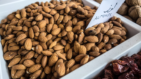 Raw fresh organic almond nuts in the tray on the counter of the Arab market. Exotic oriental spice.の写真素材
