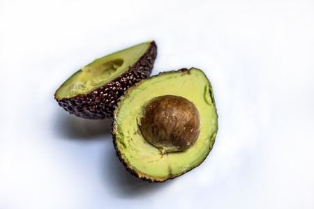 Beautiful ripe black fruit avocado variety Hass isolated on white background may use for product...