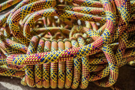 Multi-colored rock climbing ropes in bundles. Macro detail of a nylon rope. Background of the coiled sport climbing rope.の写真素材