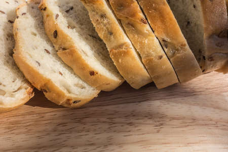 Sliced organic bread with cereal seeds on a wooden background.sliced organic bread composed of oats...