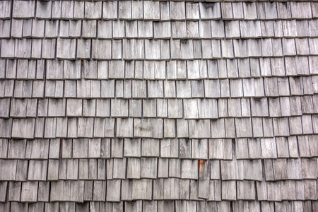 Abstract texture of wooden tile roof. Aged wooden shingle background. Shake roof shingles imageの写真素材