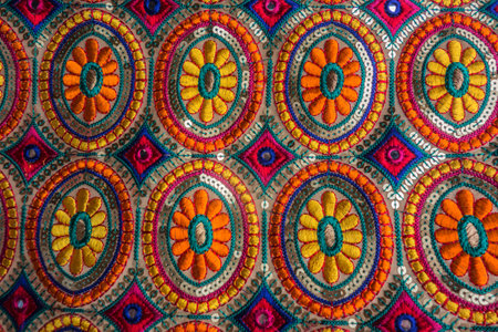 Vintage floral pattern of Arabic tablecloth close-up. Hand-knitted napkin under the objects of the Qatari home. The beauty of the interior of the Arabs. Handmade weaved carpet.の写真素材