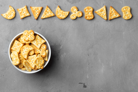 Dry salty cracker cookies on gray stone background.の写真素材