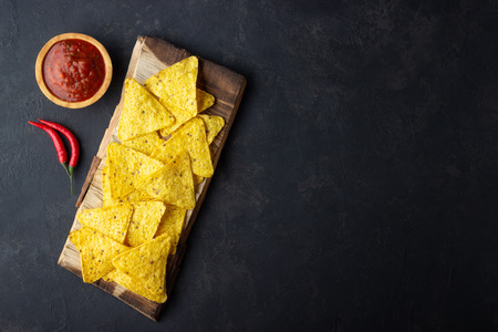 Traditional Mexican food corn chips nachos with salsa sauce on black background. Top view with copy space.の写真素材